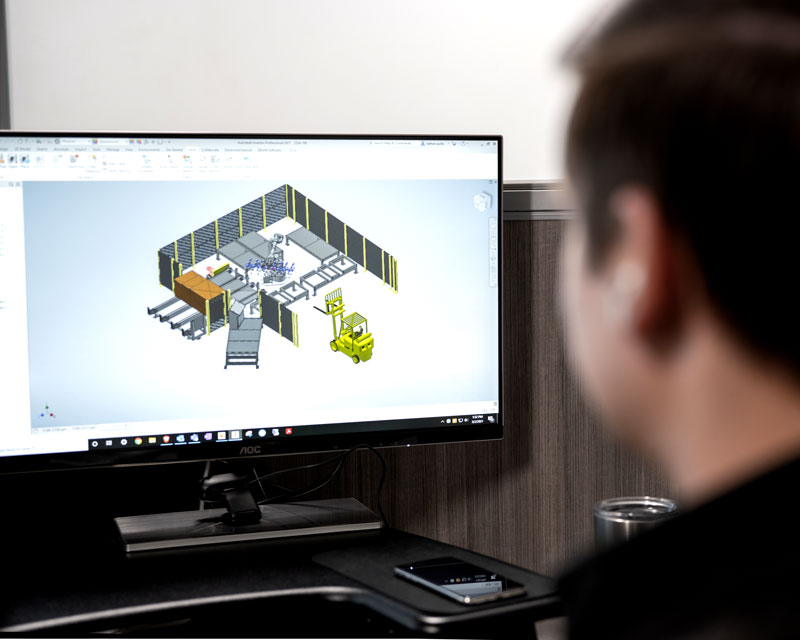 Con-Vey mechanical engineer working on 3D rendering in Autodesk software on desktop computer