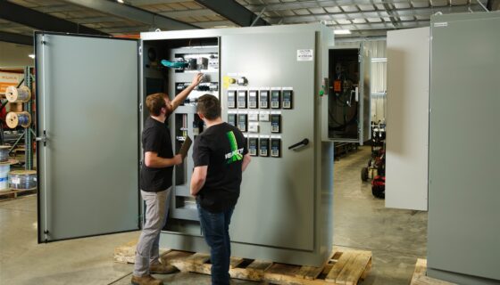 Con-Vey team members test a controls cabinet