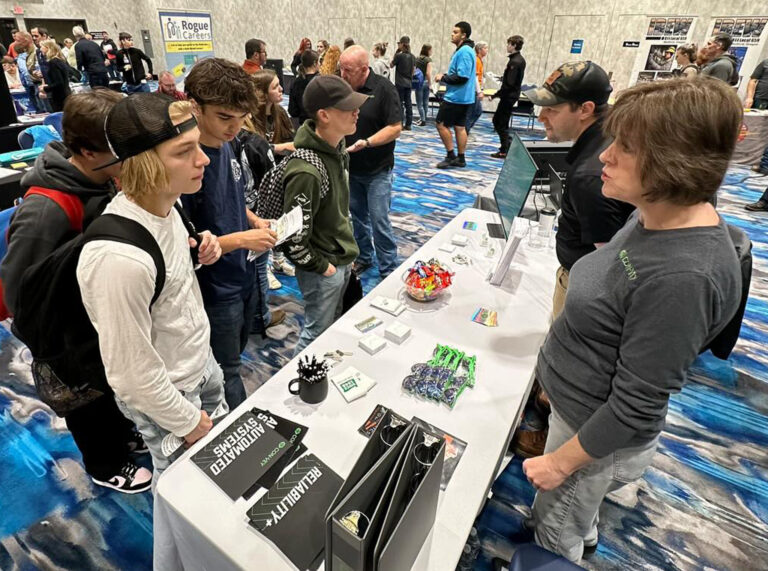 High school students stop by the Con-Vey table at a career fair