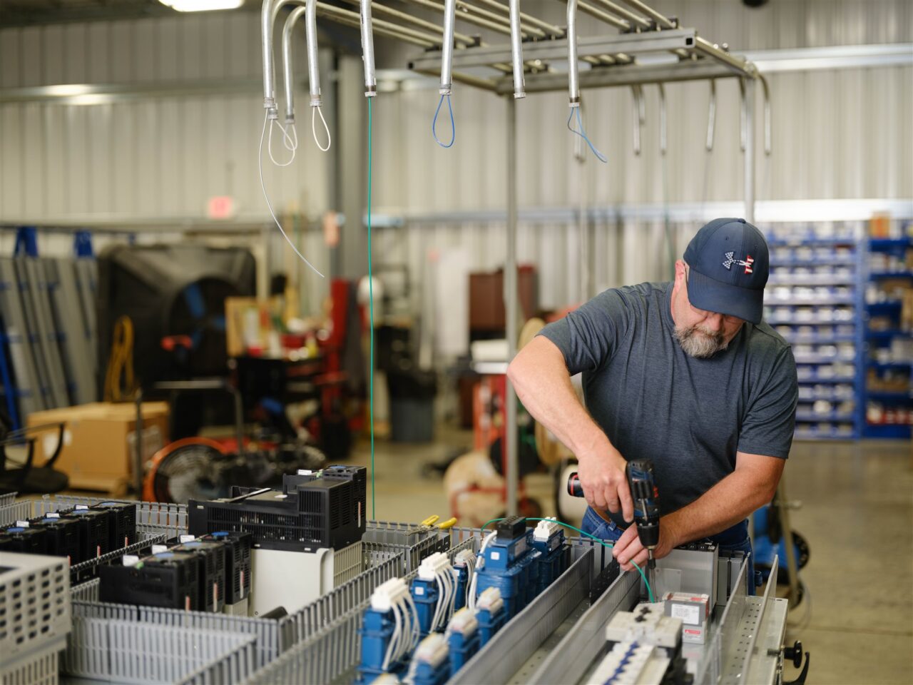 An electrical technician assembles a controls cabinet