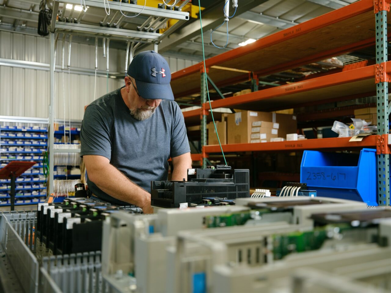 An electrical technician assembles a controls cabinet