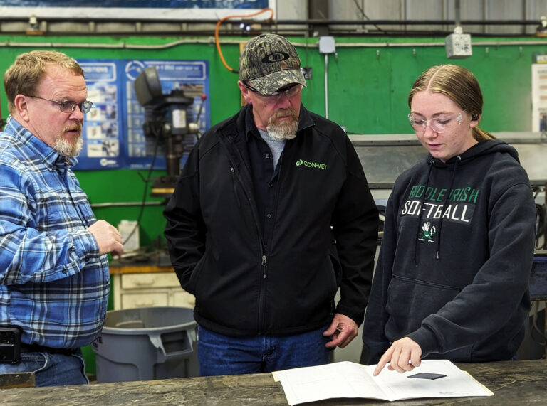 A high school student from the Roseburg community speaks with a leader from Con-Vey