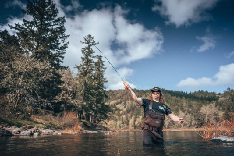 A fly-fisherman casts while wading in a river near Roseburg